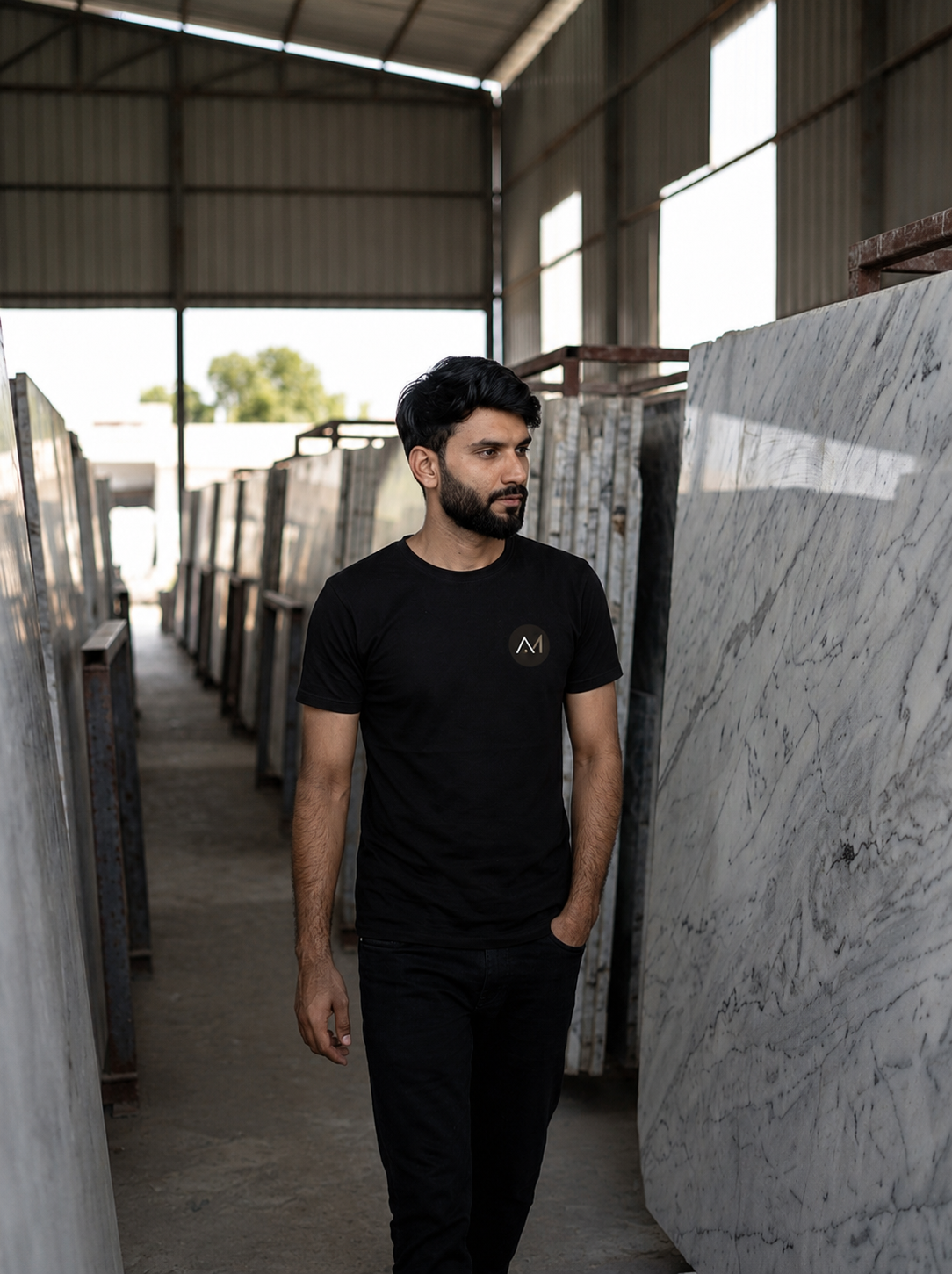 Yash in an authentic Kishangarh marble environment wearing a black Apna Marble T-shirt